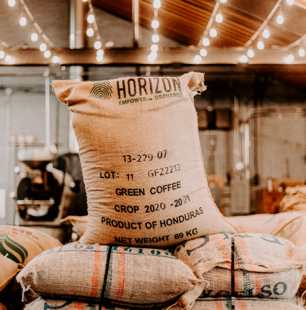 Bag of coffee beans in a fabric sack with writing "Horizon, product of Honduras"