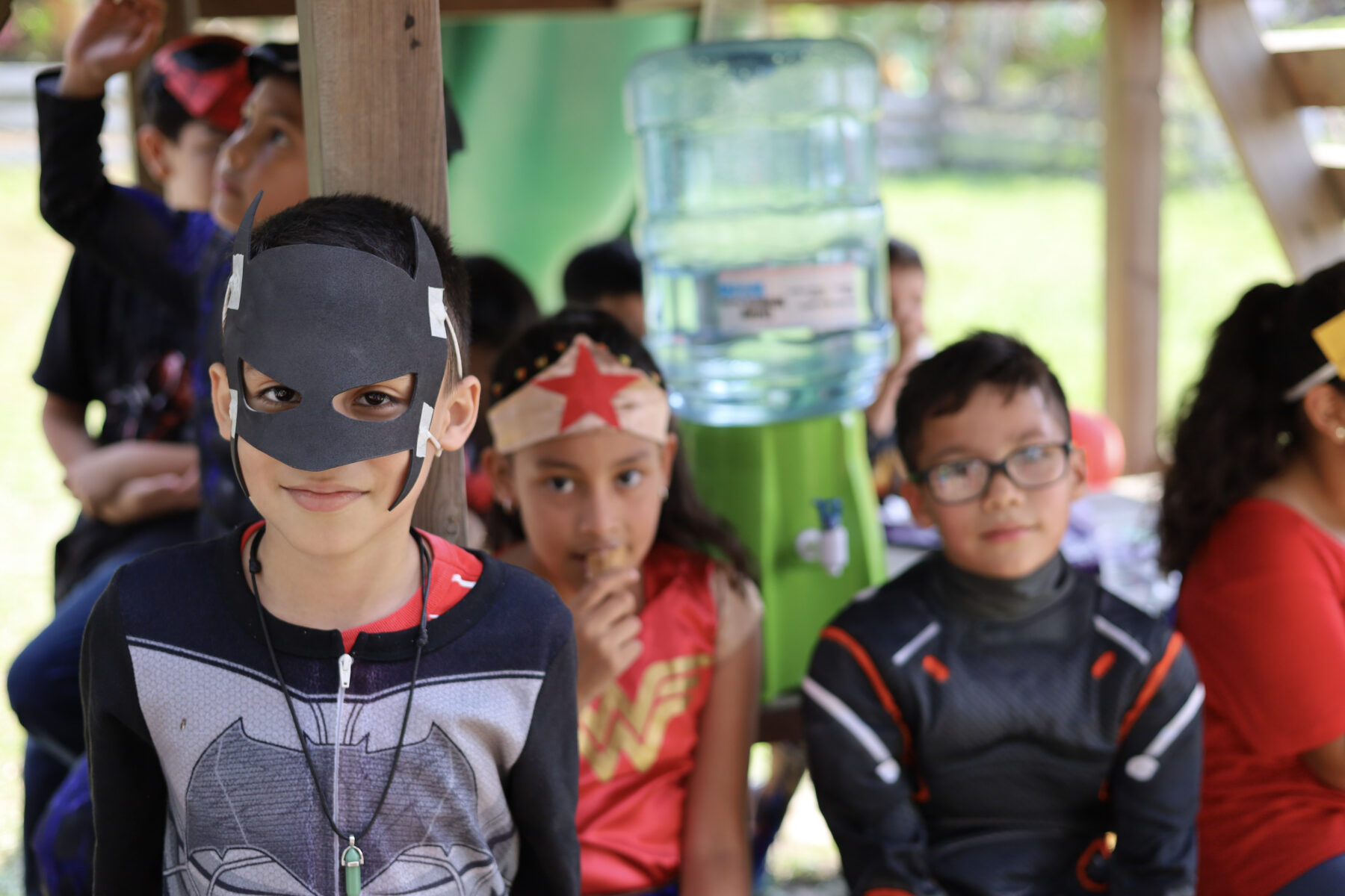 Three children in super hero costumes